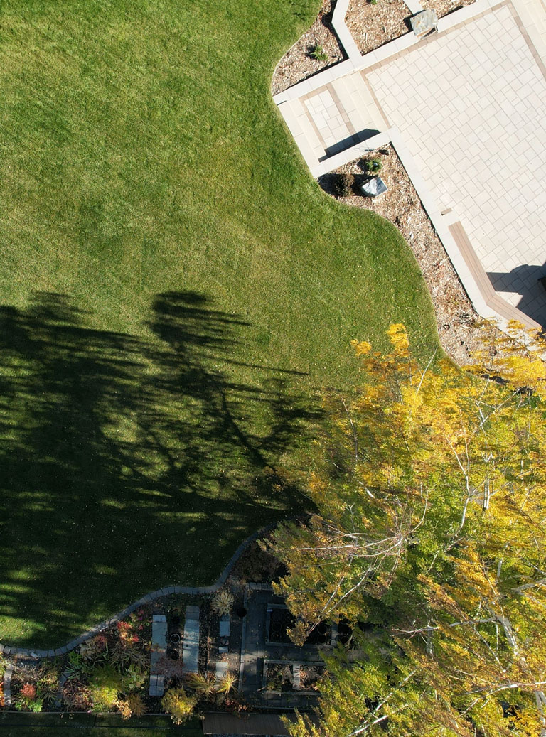 Aerial view of landscaped yard and patio mobile