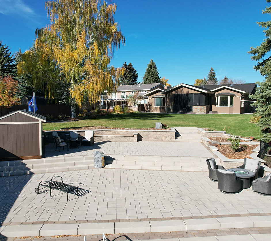 Beautiful landscaped backyard with stone patio