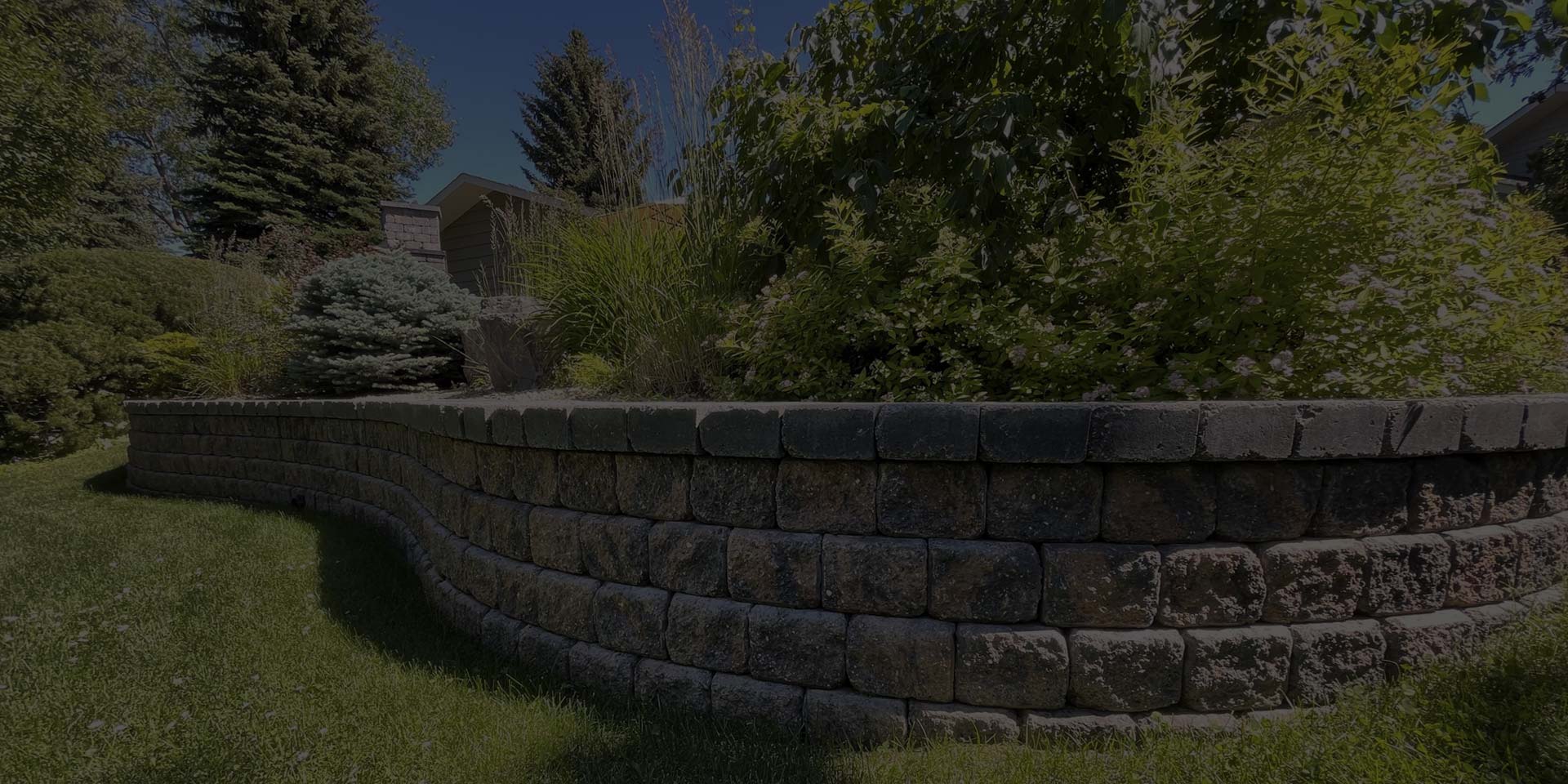 Garden retaining wall with shrubs