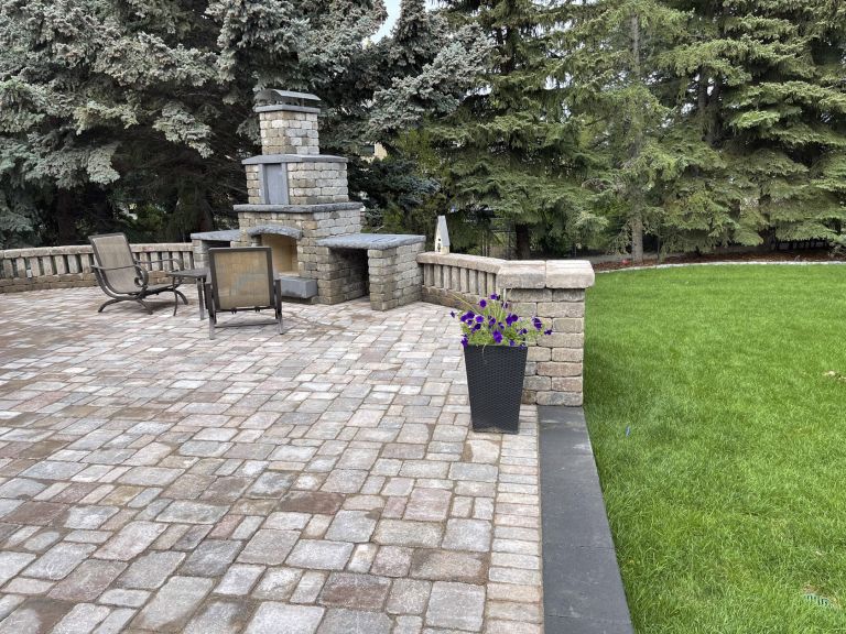 Large outdoor fireplace with stone patio 768x576