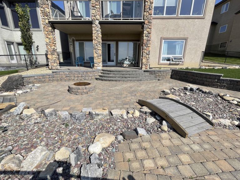 Large paver patio with bridge and firepit 768x576