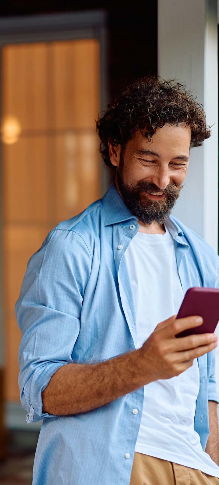 Man smiling while looking at phone mobile