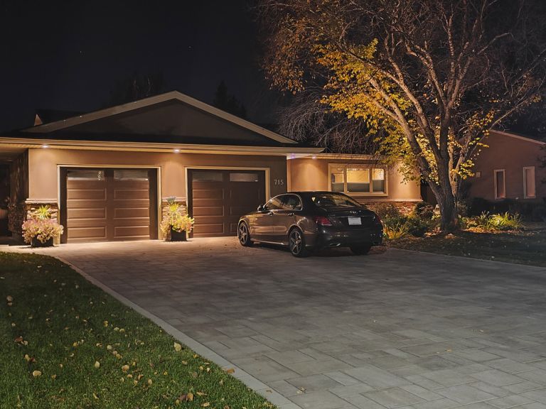 Paver driveway night with car 768x576
