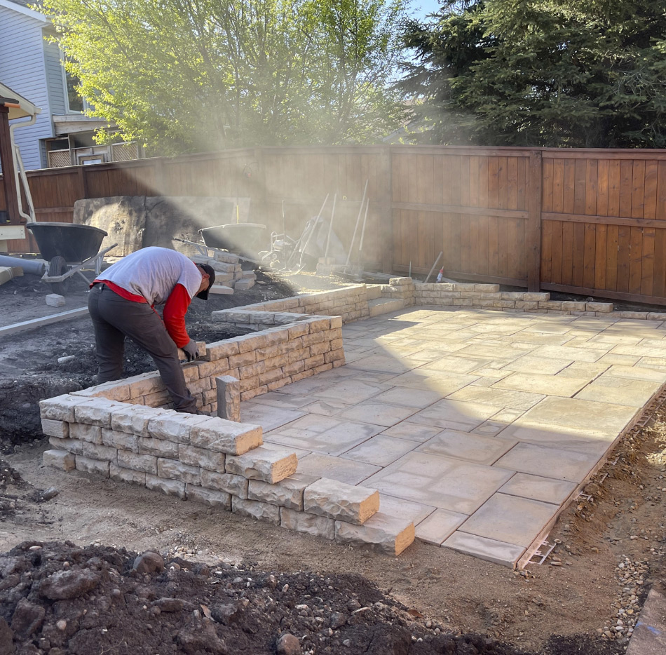 Stone mason building paver patio